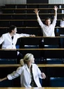 STDK. Student rasing his arms in lecture hall